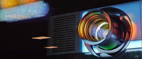 A projector throwing a picture onto a wall