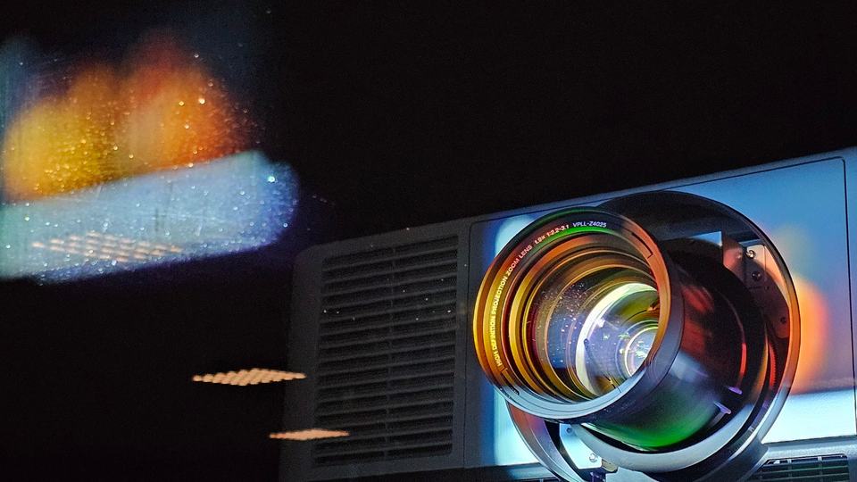 A projector throwing a picture onto a wall