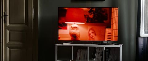 A television on a stand in a dark living room