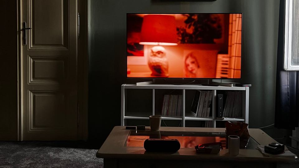 A television on a stand in a dark living room