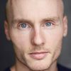 Zak Rowlands as Baldini