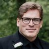 Paul Ruddy as Casting Director