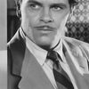 Edmund MacDonald as 'Murder at Midnight' Announcer