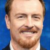 Toby Stephens as Frank Warren