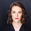Britt MacLennan as GDA Host