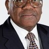 Trevor McDonald as Newscaster