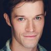 Dylan Grunn as The Facilitator