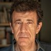 Manolis Mavromatakis as The Shopkeeper