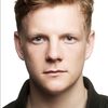 Patrick Gibson as Rex, the Clapper Loader