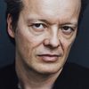 Pascal Ulli as Bruce Baxter