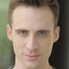 Matthew Zuk as Wounded Man with Crucifix