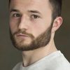 Ian Dunnett Jnr as PR Officer Raymond Hollman
