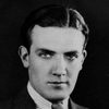 John Longden as Passport officer