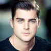 Liam Doyle as The Hooded Stranger