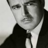 Patric Knowles as Dr. Roger Gretorex