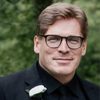 Paul Ruddy as Casting Director