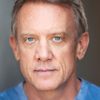 Simon Burke as Greg Owens