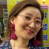 Kang Sook as Volunteer 2 from charity organization