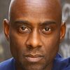 Rudy Barrow as Father Aaron