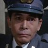 Yasuhisa Tsutsumi as Police Officer at the Dock