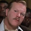 Derek Mills as Man in Court (uncredited)