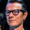 Larry Mullen Jr. as Tom