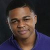 Jeremiah Craft as Louis Armstrong