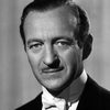 David Niven as Sir Charles Lytton