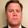 Gordon Rix as Corporate Executive