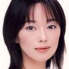 Riona Hazuki as Woman in Red