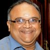 Mohan Raman as Temple priest