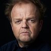 Toby Jones as Basil Shaw