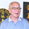 Ip Chun as Stall owner with phone