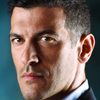 Simon Kassianides as Percy / Flynn