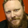 Eddie Baroo as Tom Evans