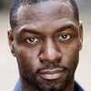 Richie Campbell as The African
