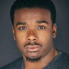 Christian Robinson as Capital A