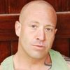 Aaron Saxton as Fitness Trainer