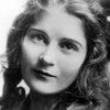 Mae Marsh as Dark Cloaked Woman at Fort Guarding Deranged Woman (uncredited)