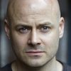 Adam McNamara as Tam
