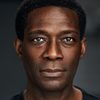 Dean McKenzie as Archbishop Desmond Mutumbo